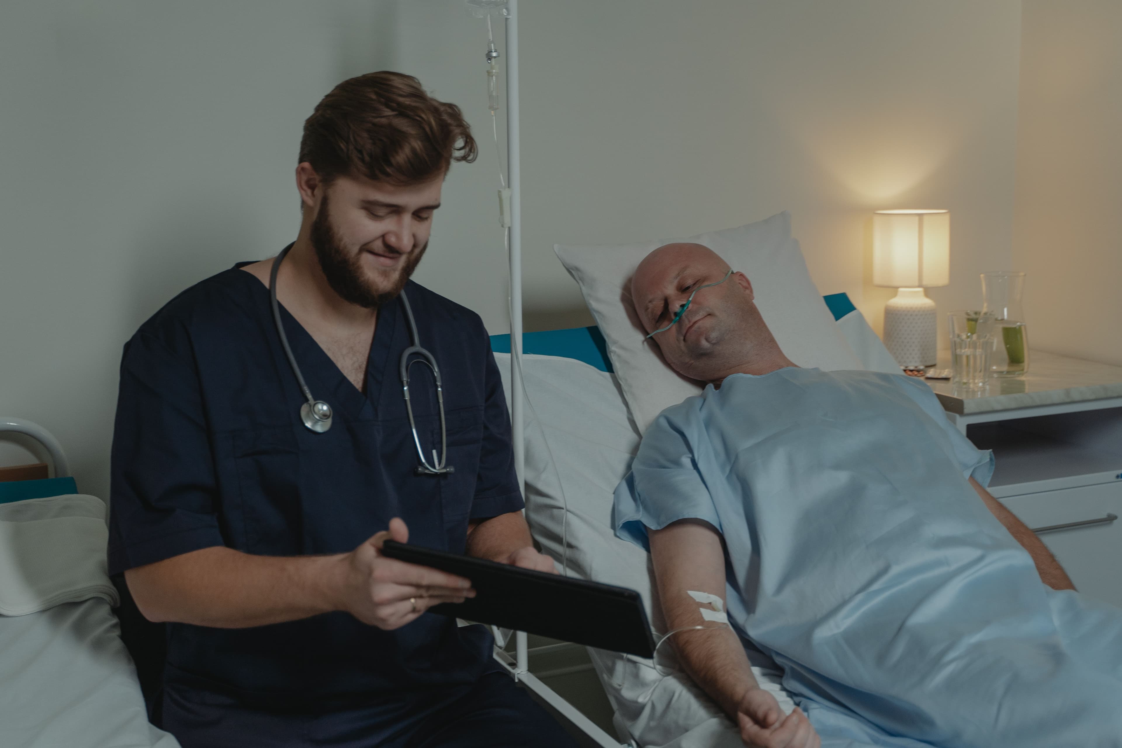 Nurse monitoring patient vitals on a tablet