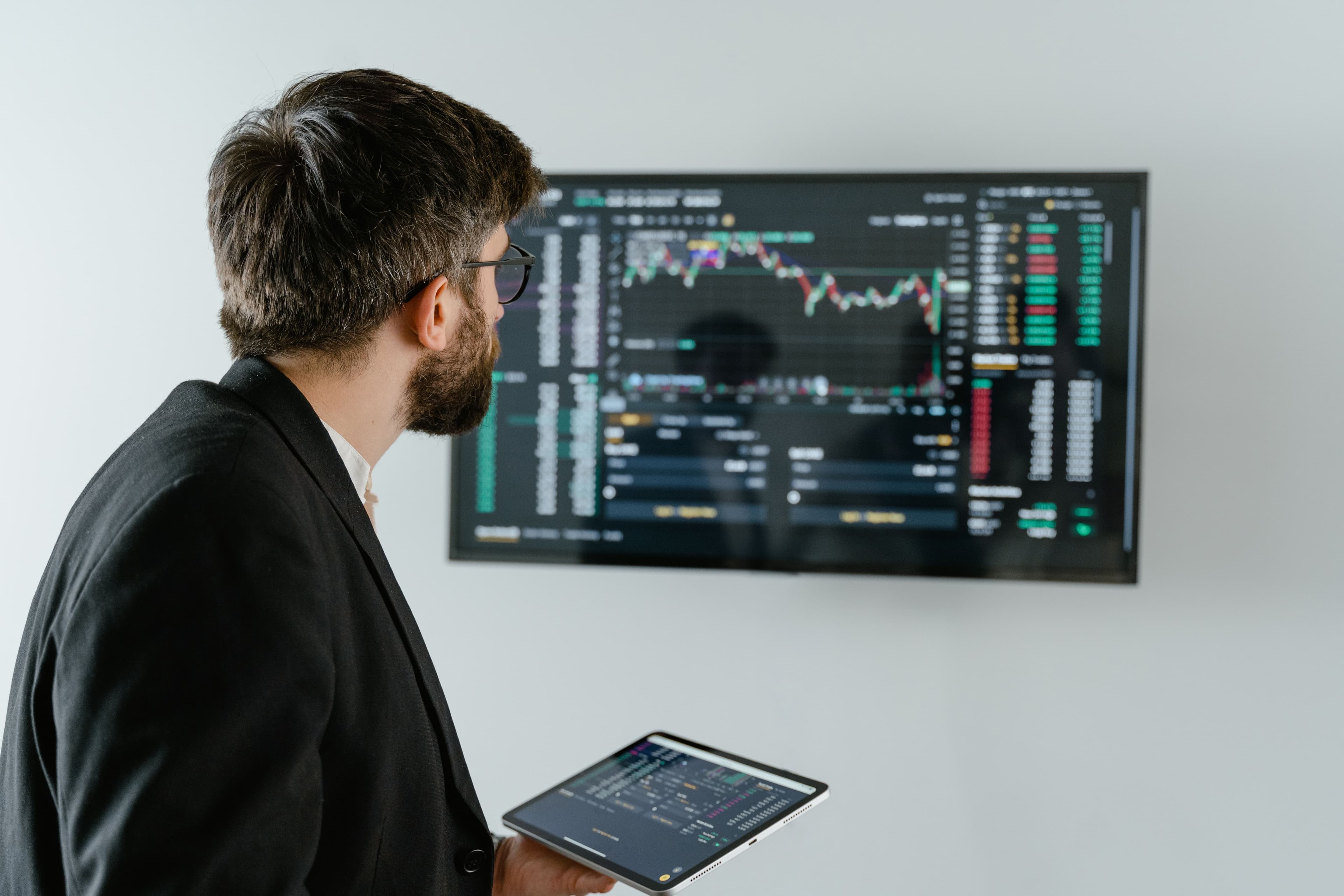 Data analyst examining a large interactive dashboard