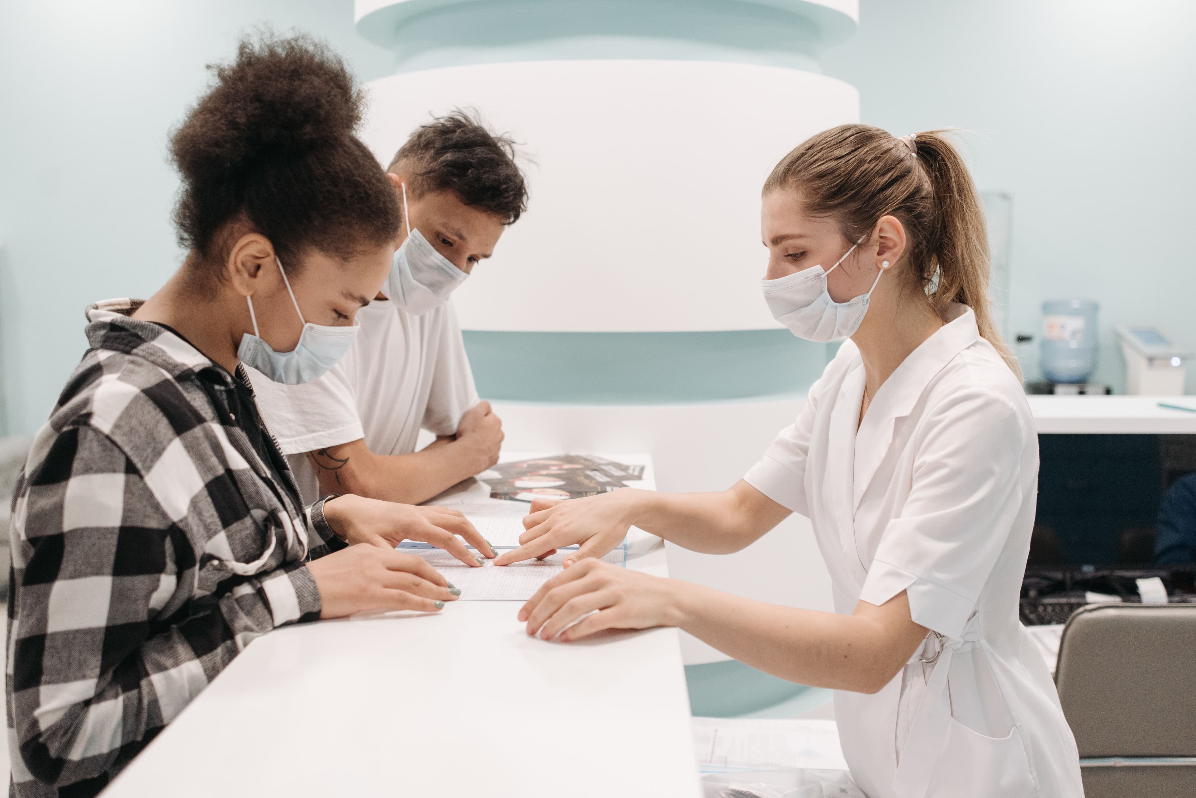 Hospital registration staff assisting a patient